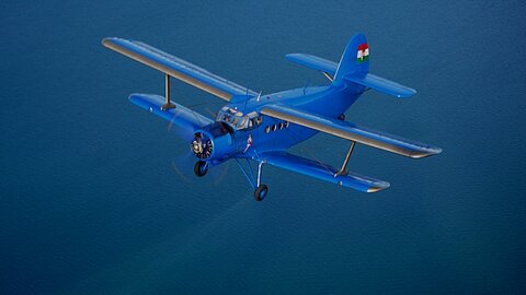 Die An-2 über dem tiefblauen Bielersee.